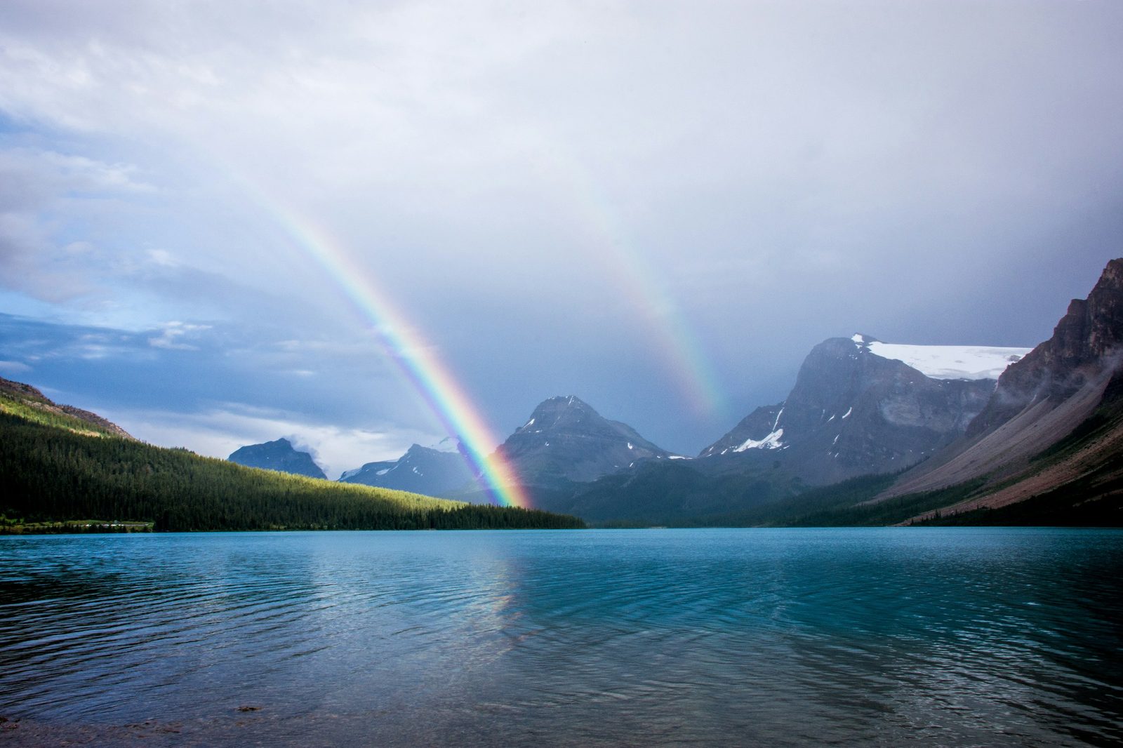 Double rainbow over a mountain lake